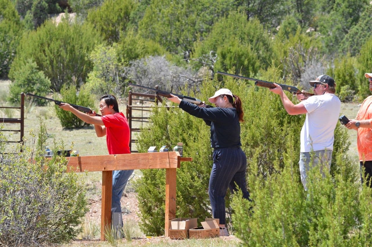 People engaged in outdoor clay pigeon shooting