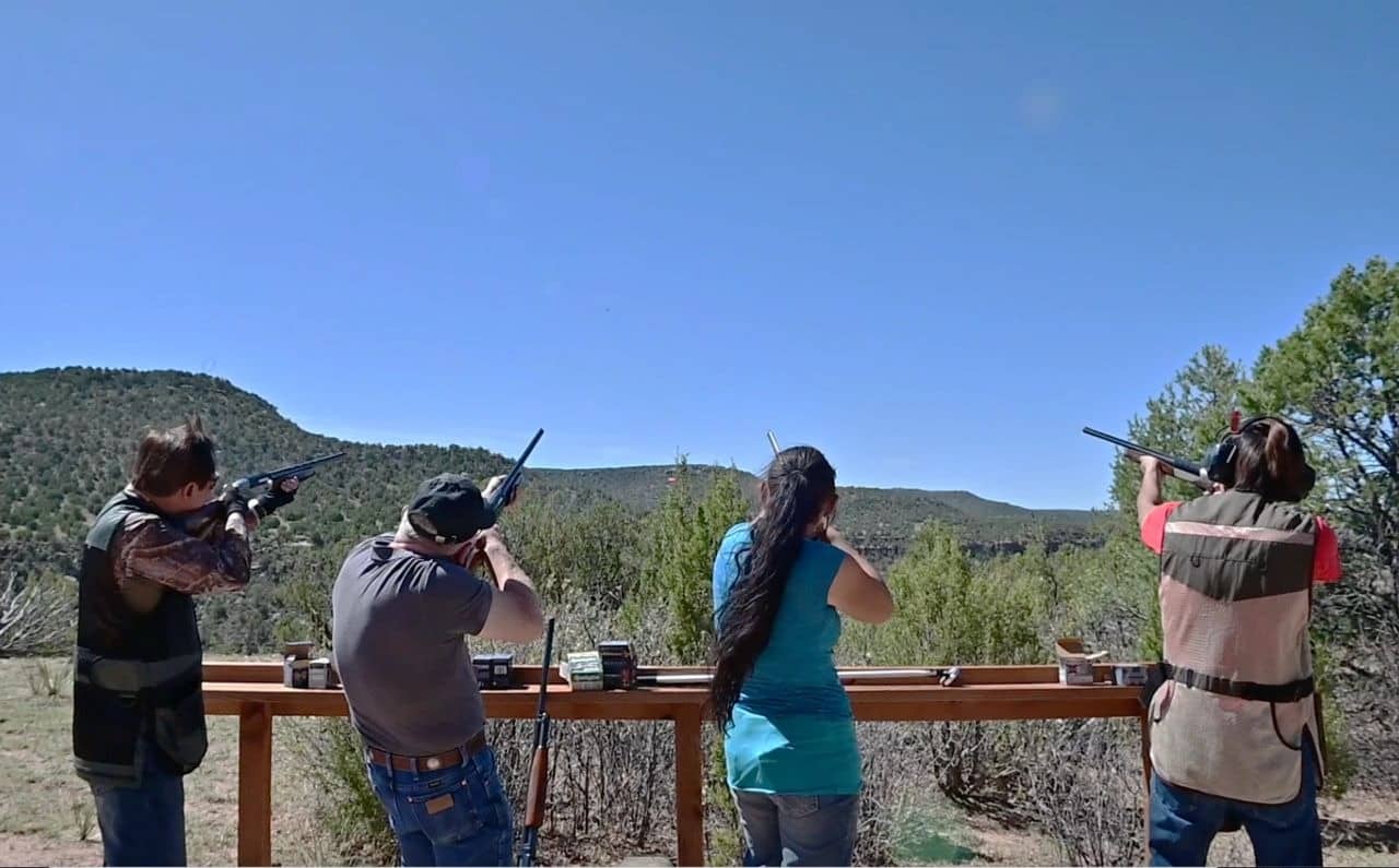 People at shooting range in scenic outdoors