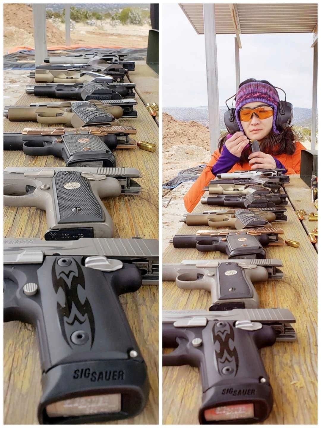 Person at shooting range with handguns displayed on table.