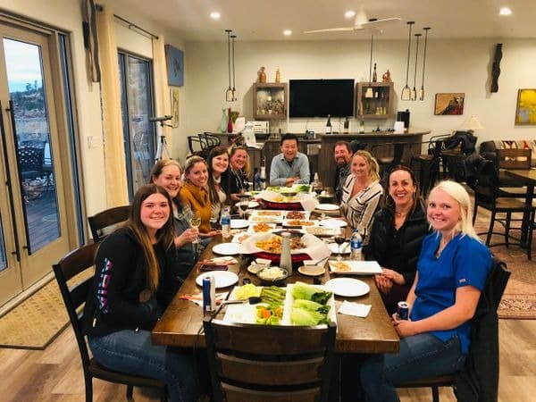 Group of people enjoying dinner together indoors.